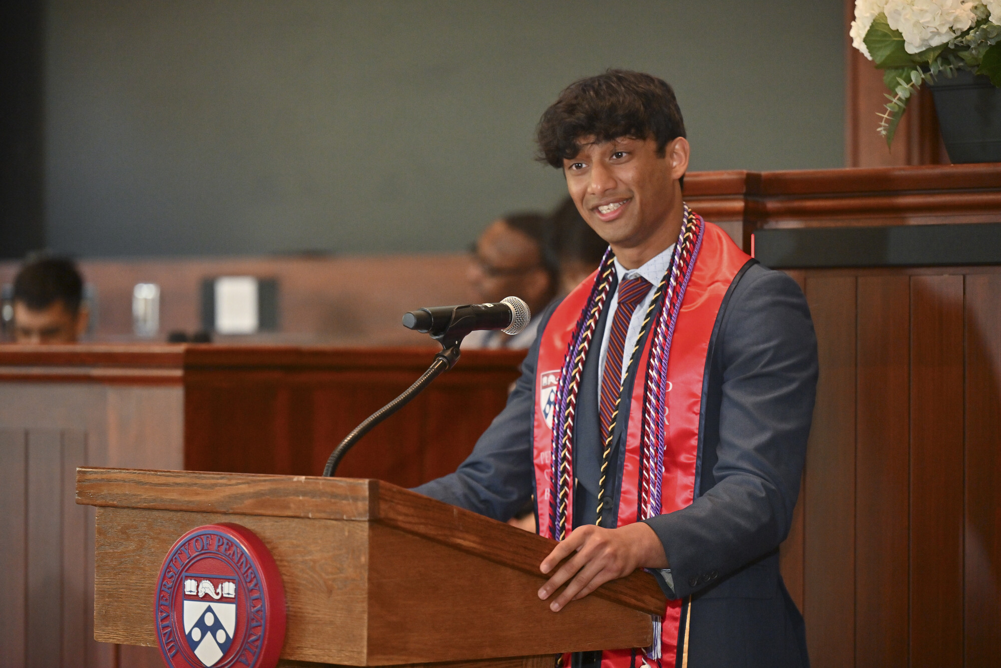 Amaan Omer speaking at the podium at the Ivy Day ceremony.