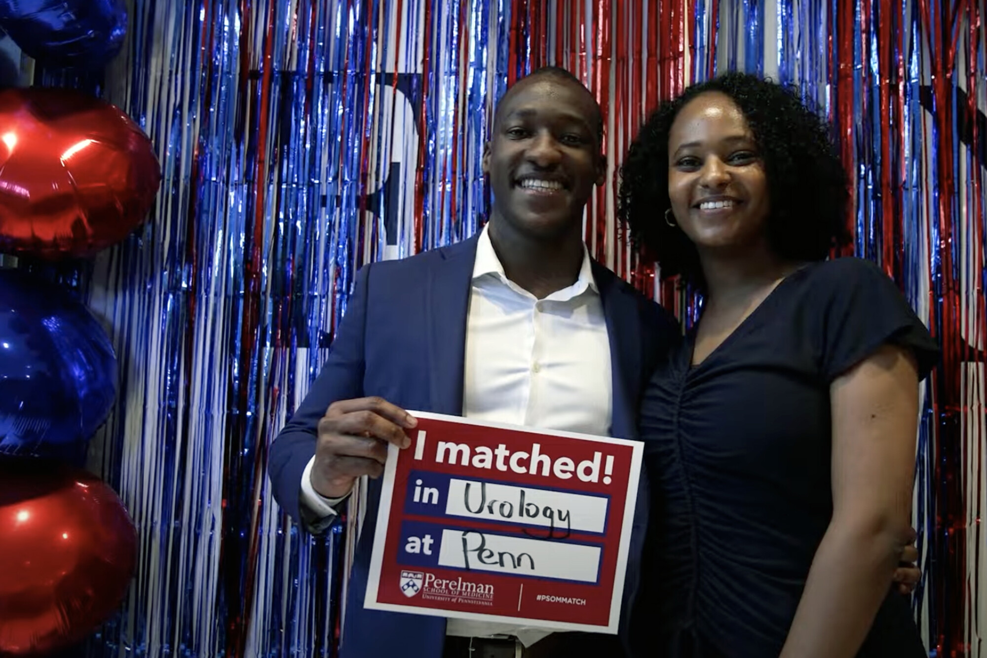 Sydney Chambule and a friend holding an “I Matched” sign at Match Day.