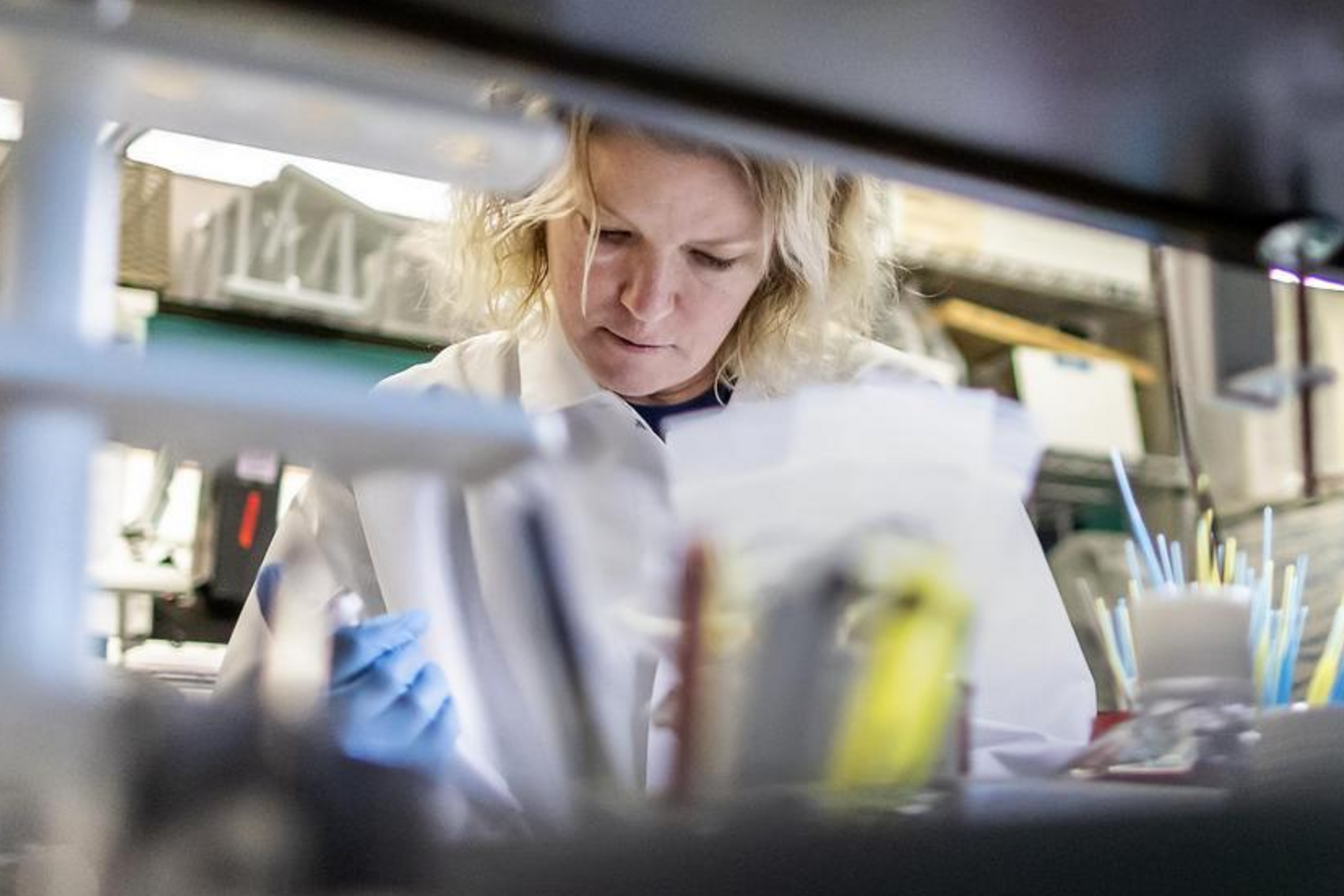 Denise Barnhart applies matrix to a target plate of bacterial isolates for identification in a lab at the New Bolton Center.