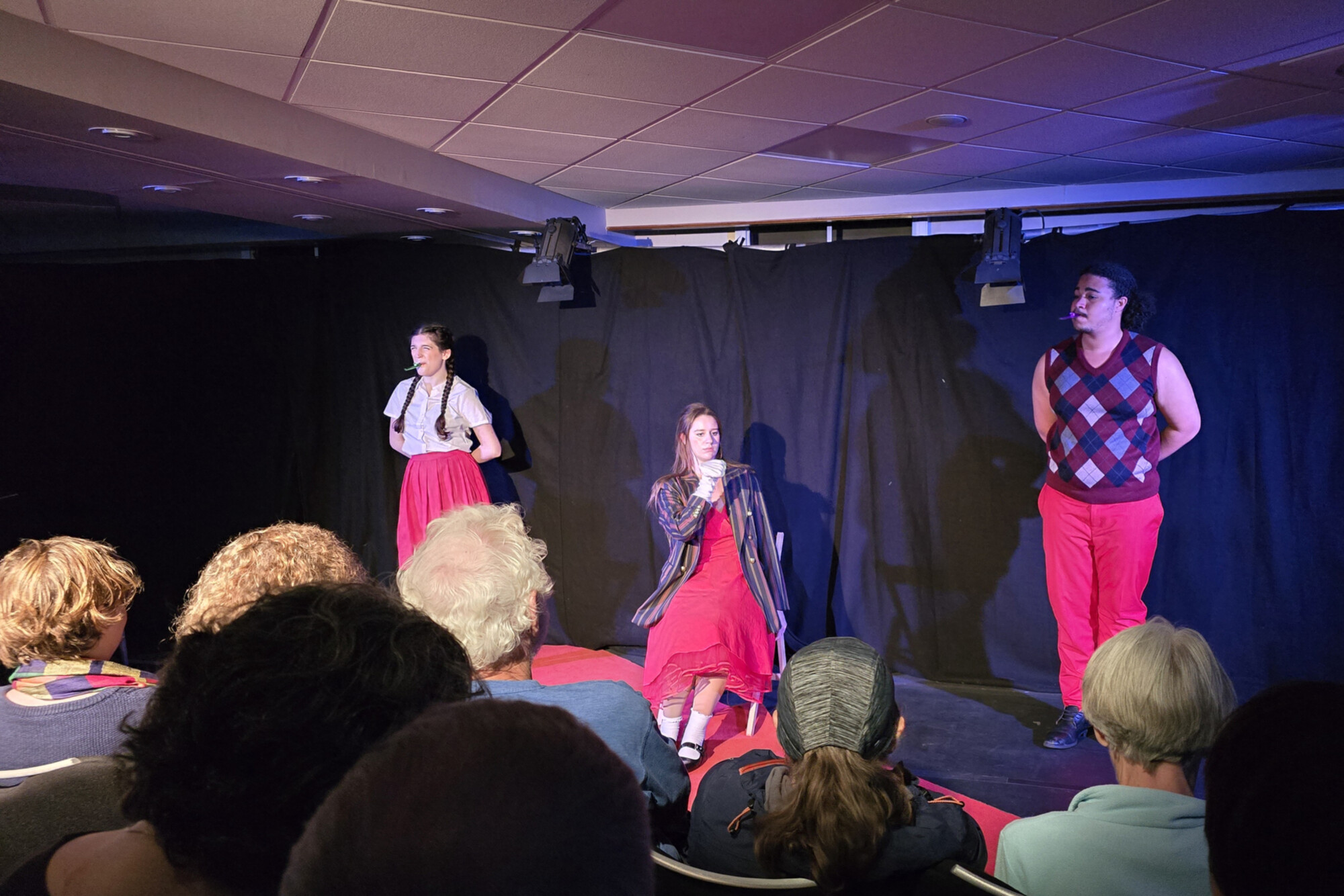 Anya Rothman, Pandora Schoen, and Elliot Ross-Dick performing for a crowd in Edinburgh.