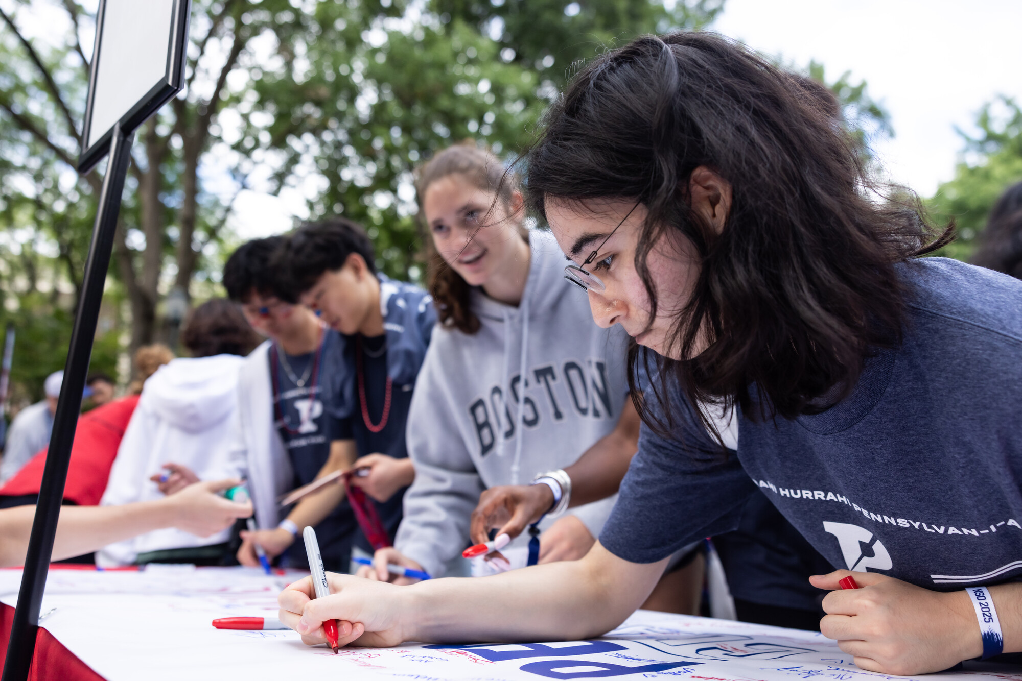 Students signing the Penn Class of 2029 banner