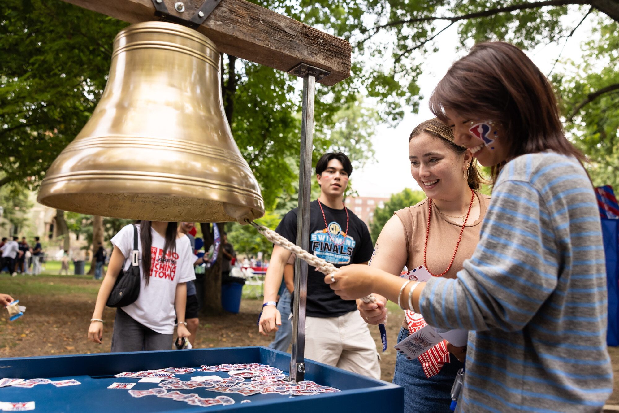 Two students ring a replica of the Liberty Bell.