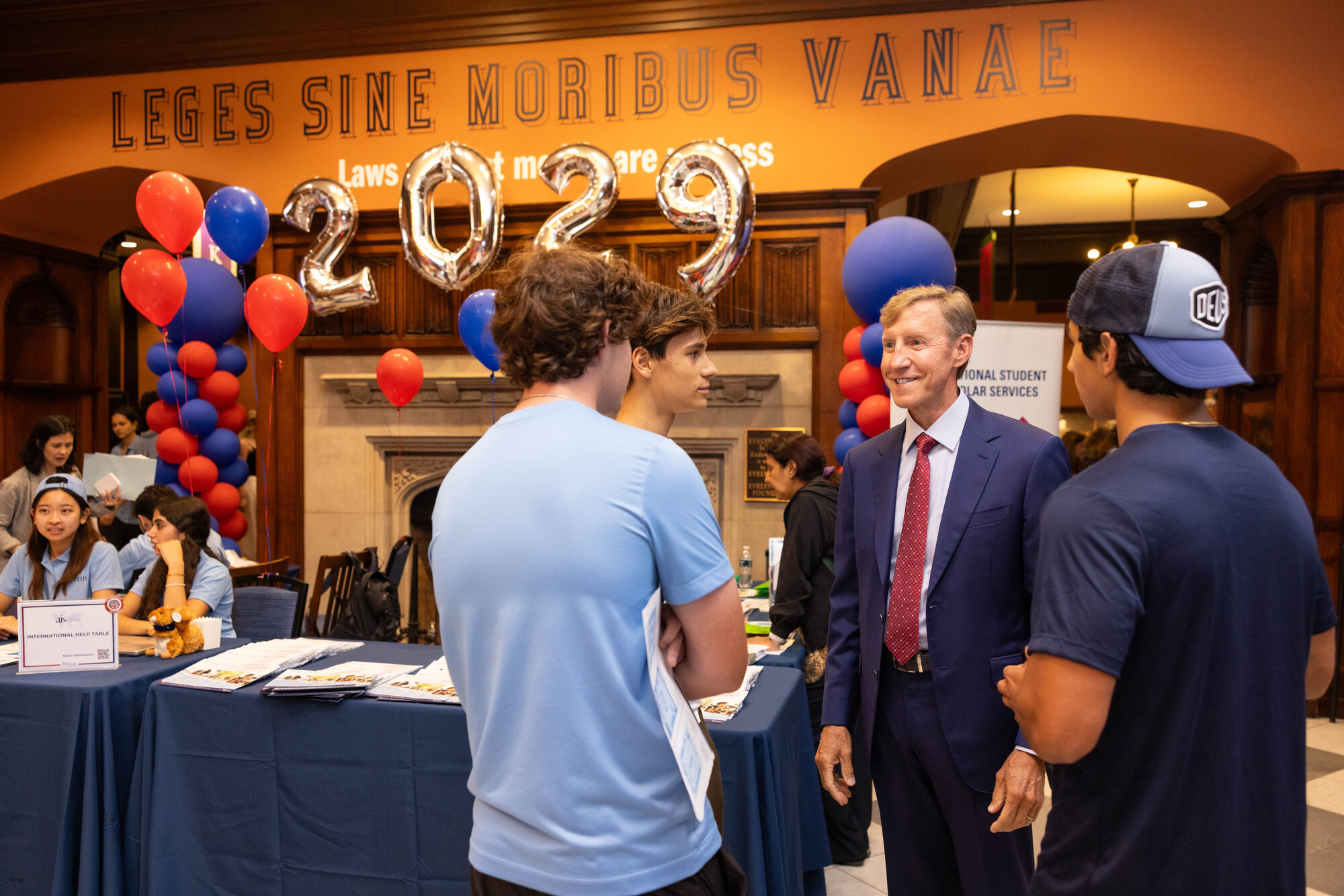 Penn President J. Larry Jameson speaking with three students at the NSO activity fair.