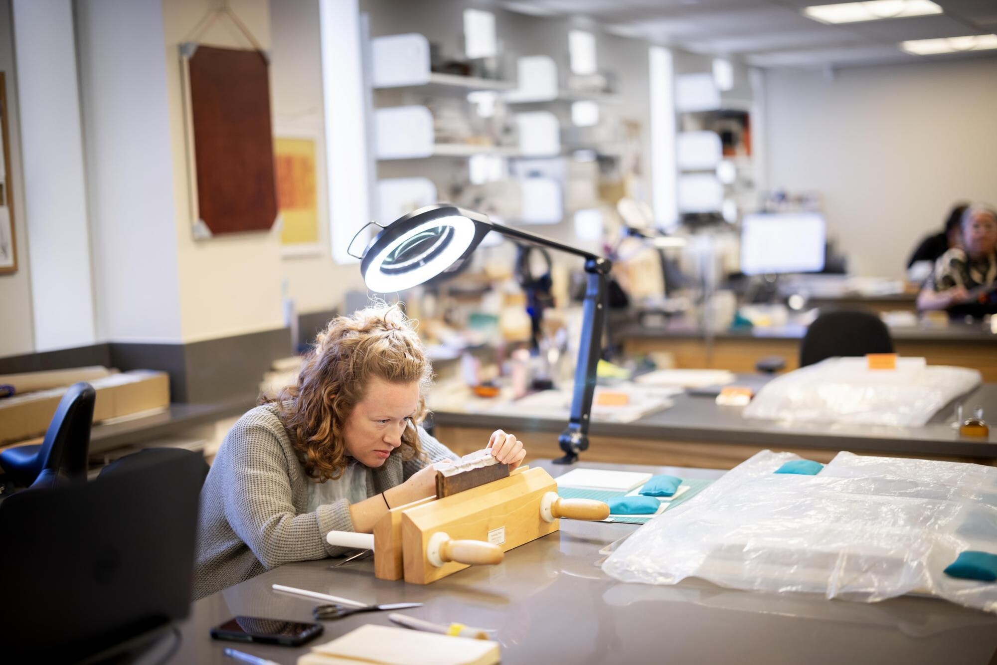 Tessa Gadomski treating a book in the Conservation Lab.
