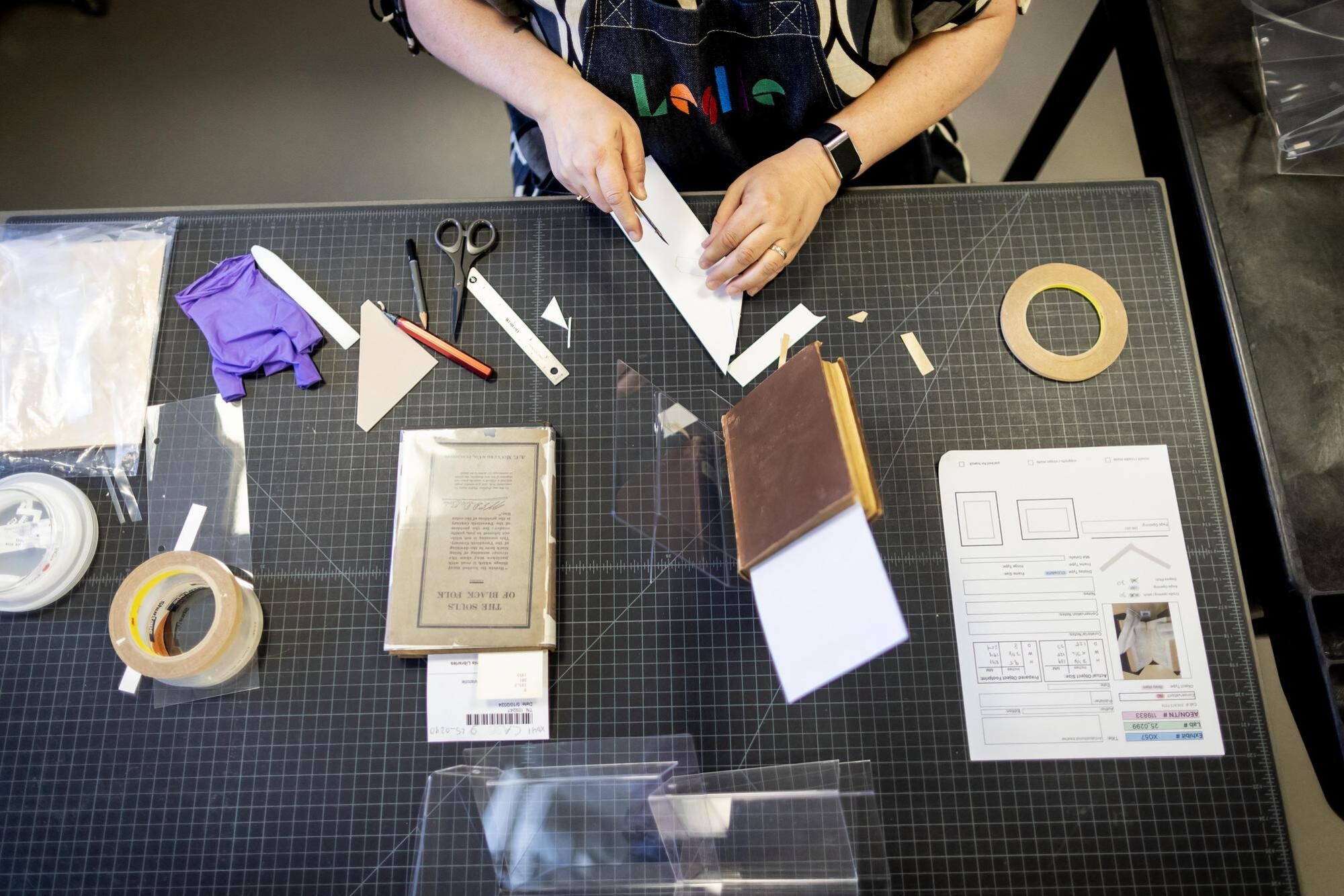 A person working on book materials in the Libraries Conservation office.