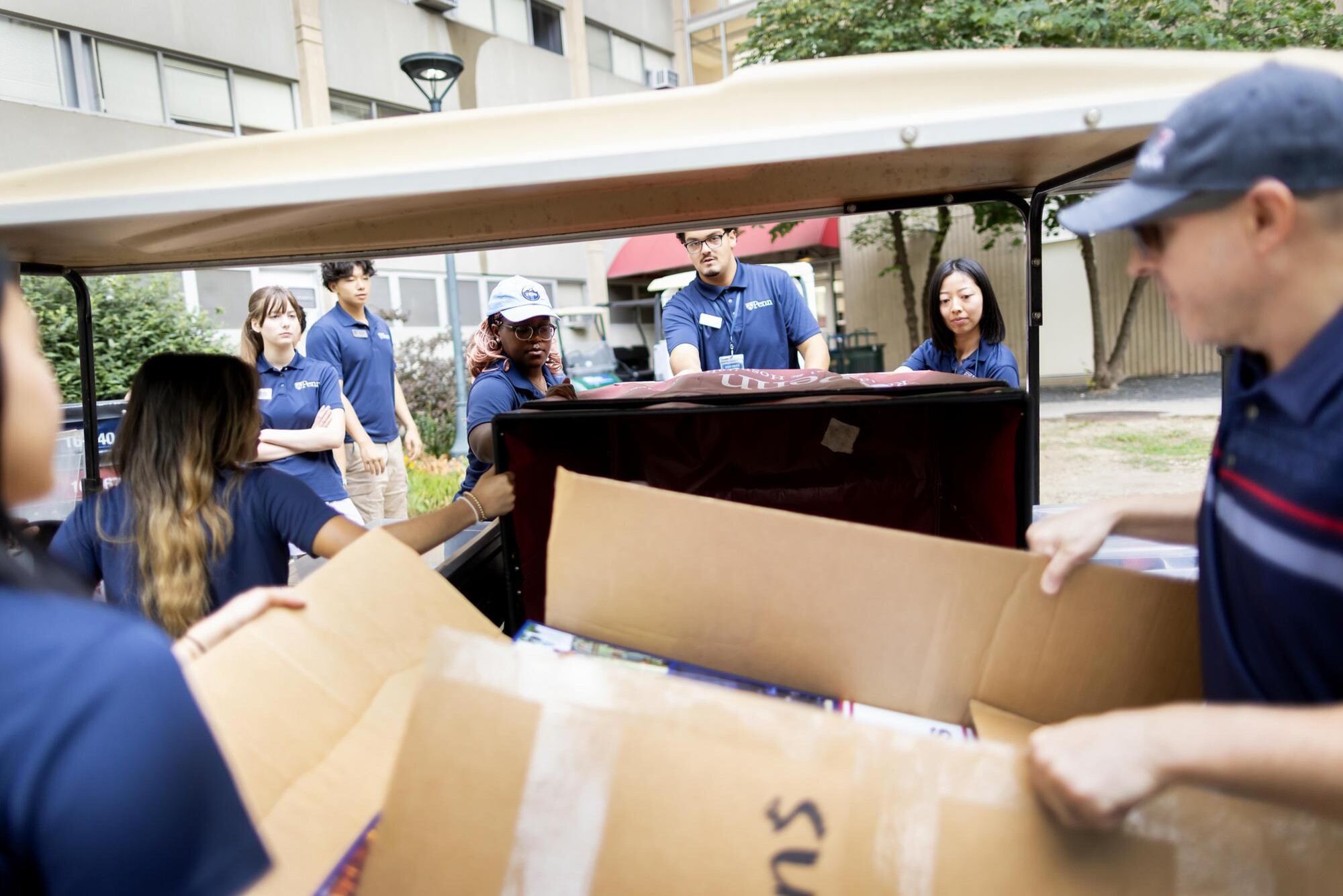 Students unloading boxes from a Penn cart before Move-In