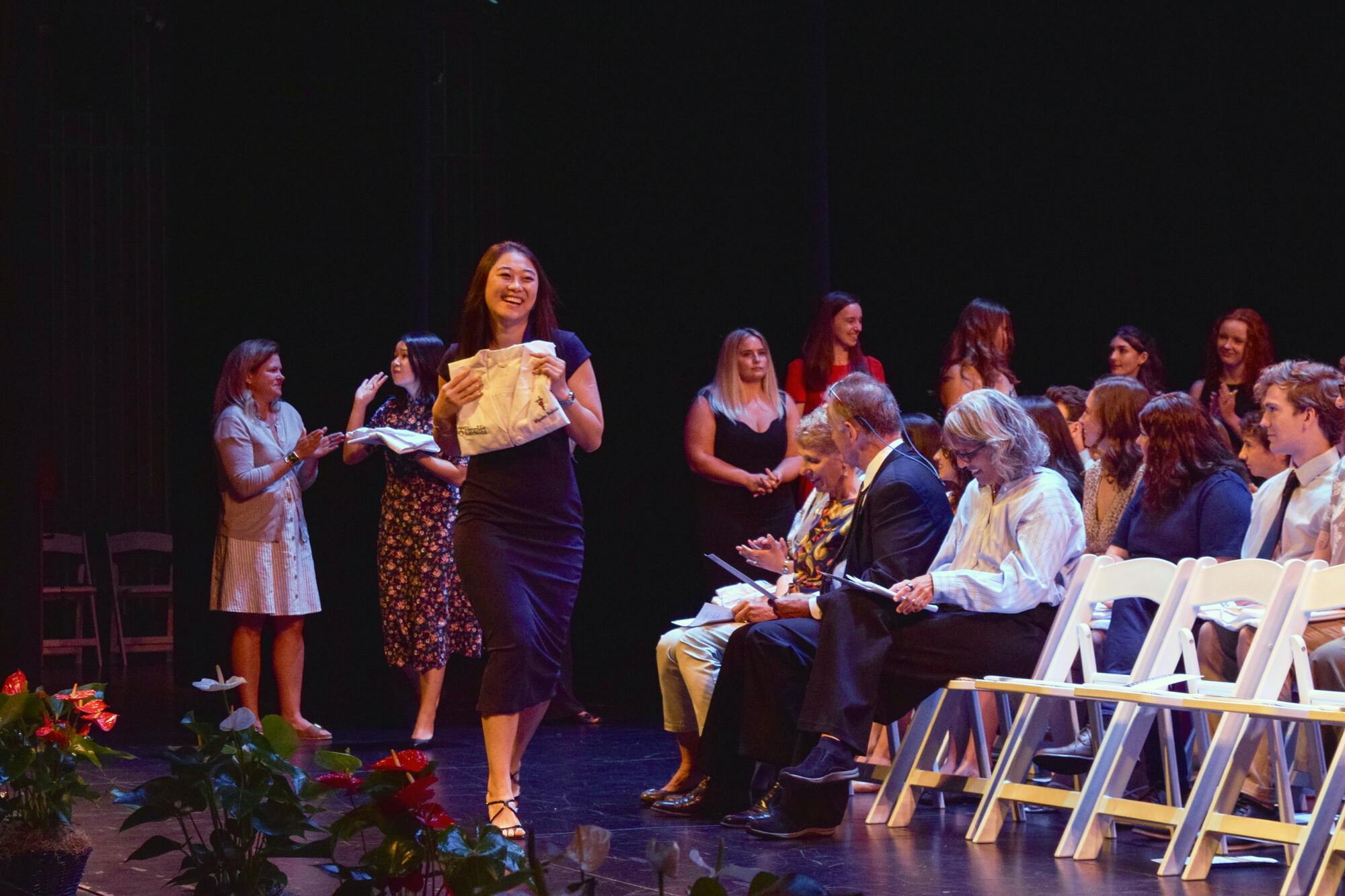 A student holding their white coat at Penn Vet’s White Coat Ceremony.