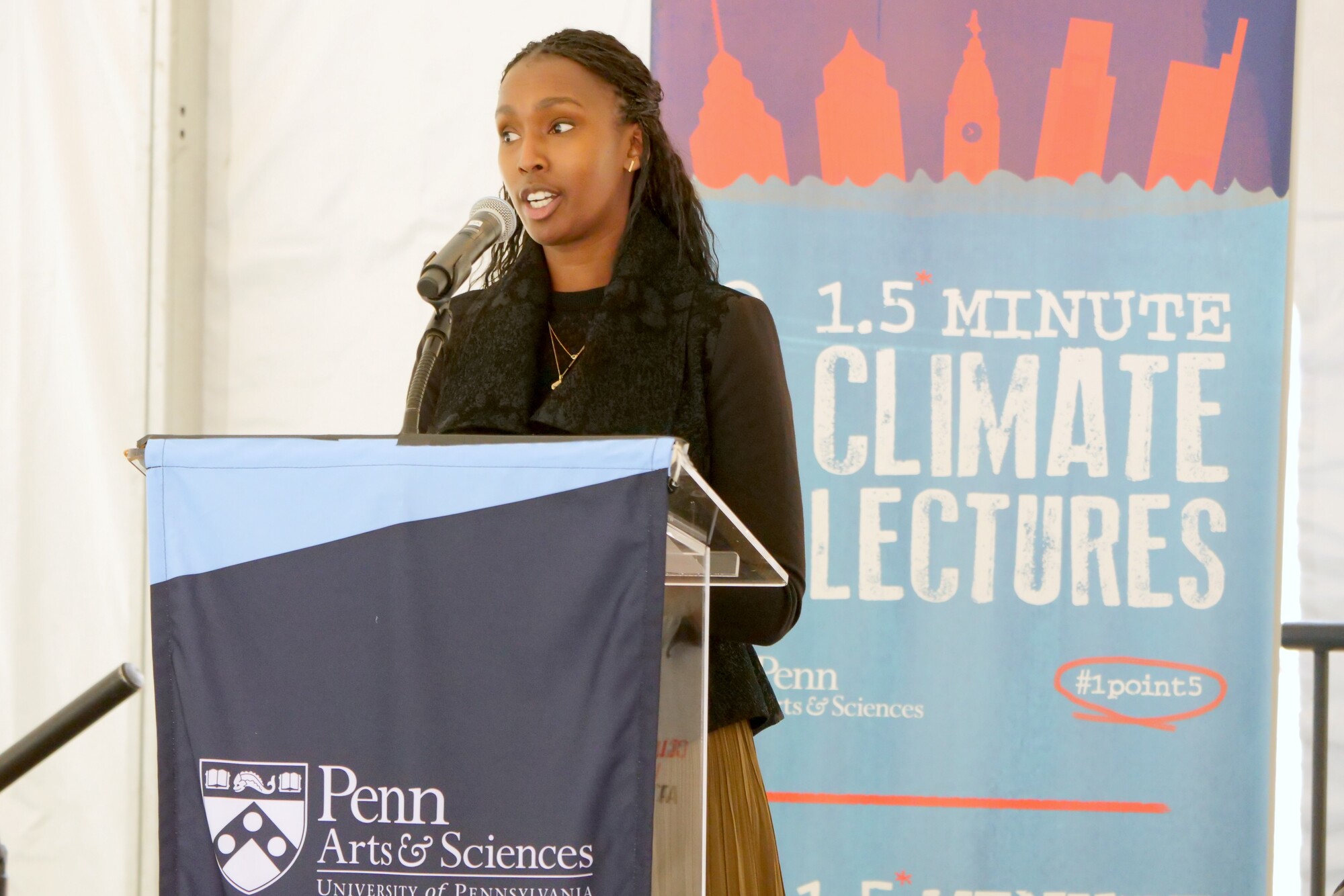 A person speaking at a podium during Penn’s 1.5 Minute Climate Lectures.