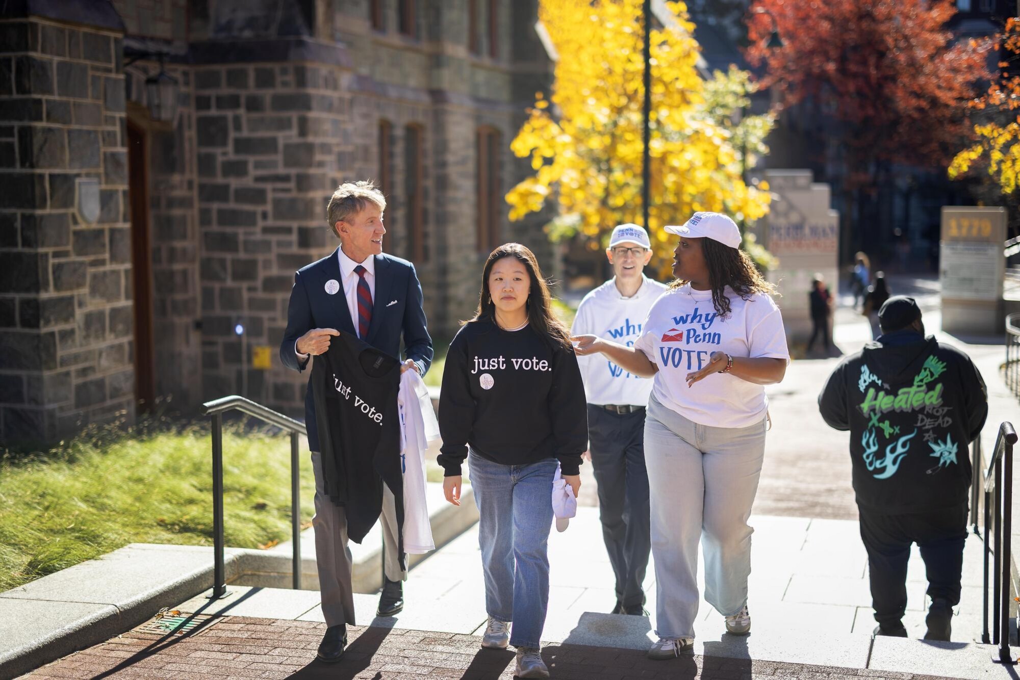 Penn President J. Larry Jameson walking outside with members of Penn Leads the Vote.