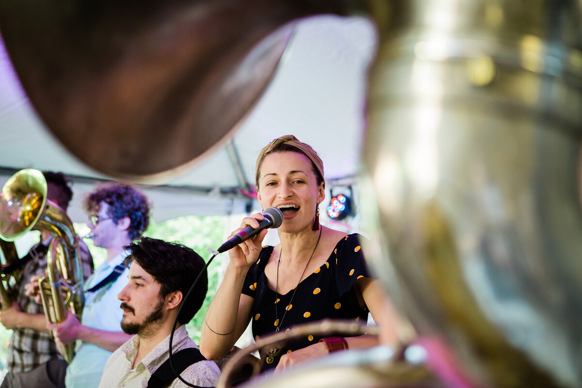 A performer from the West Philadelphia Orchestra sings into a mic