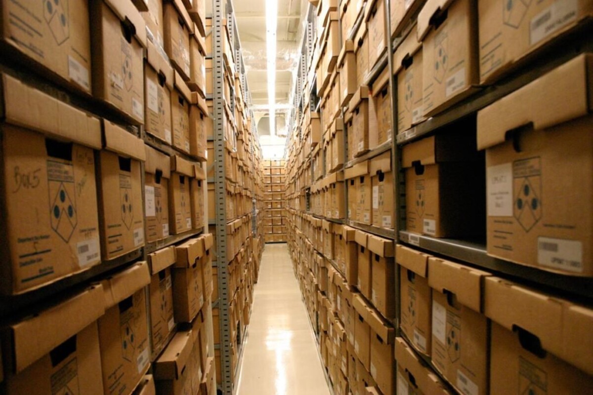a tall aisle of cardboard boxes