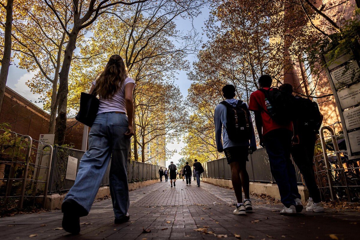 People walking on Locust Walk in the fall.
