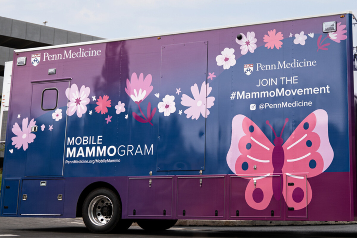 Penn Medicine's mobile mammogram van. The vehicle is a blend of pink, blue, and violet, with a pink butterfly design.