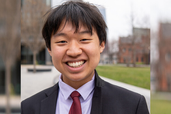 Joey Wu standing outside wearing a suit and tie