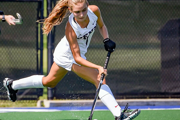 Sydney Mandato swings at the ball with her stick during a game.