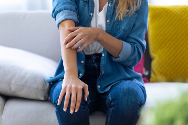 Person scratching an itch on their right arm.