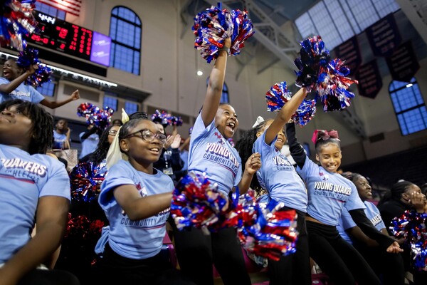 West Philadelphia students cheer on Penn Women's Basketball, waving pompoms