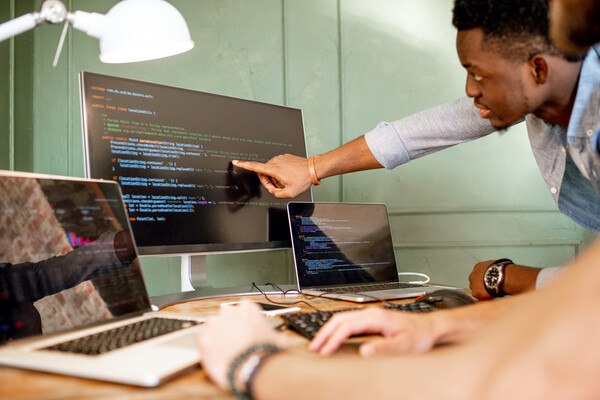 Two developers working on computer screens.