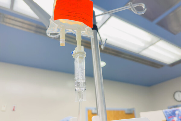 An infusion bag hanging in a hospital room.