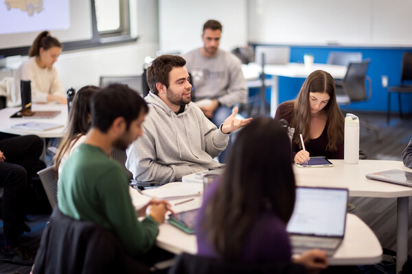 A group of students at Penn in class at a table.