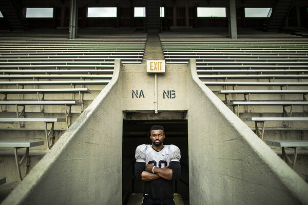 portrait-of-brooks-arms-crossed-at-bleachers