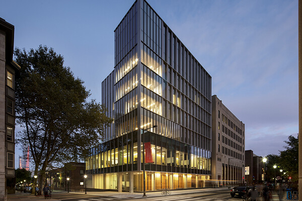 a picture with night view of the facade of the perelman center for political science and economics