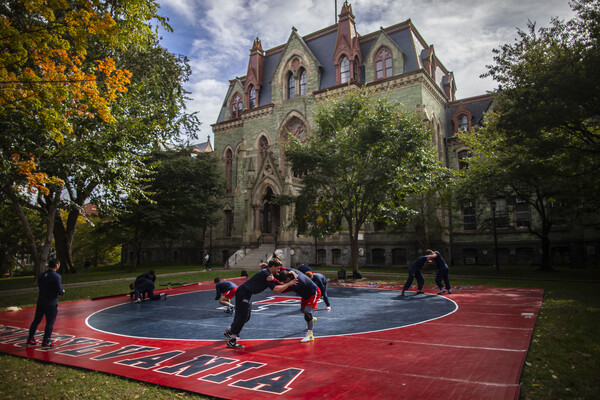 wrestling-team-practicing-outdoors-with-college-hall-in-background