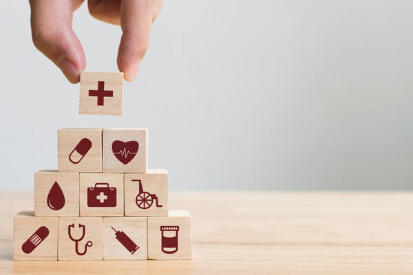 building blocks with prints of pills stethoscope and needle