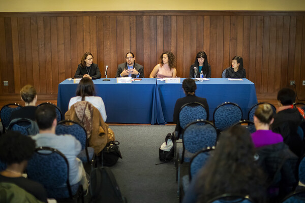 five-peope-at-a-table-in-a-panel-discussion