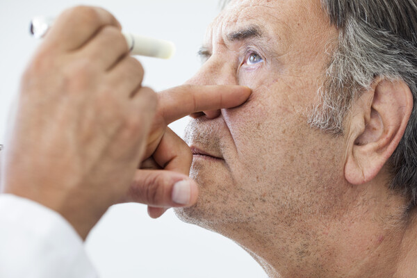 Older man has eye examined 