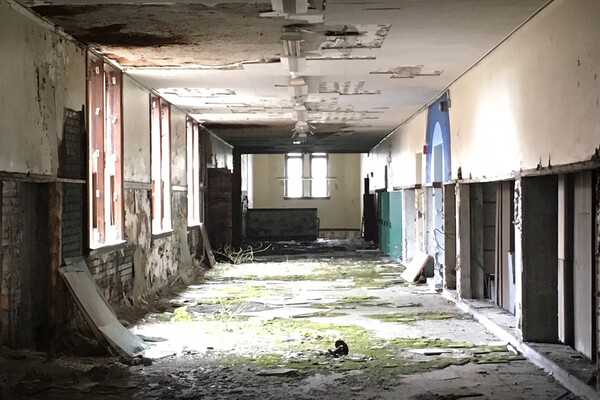 interior of abandoned building with sunlight coming in from windows
