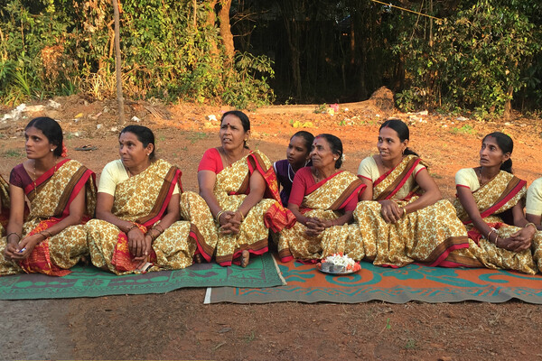 Women from a small self-help group movement in India sit at a community meeting with members of the SP2 research project. 