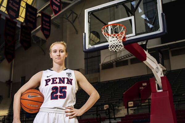 Ashley Russell of the women's basketball team poses with a ball on the Palestra court.