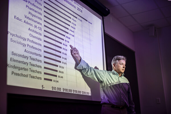 Richard Ingersoll lecturing and pointing at a screen