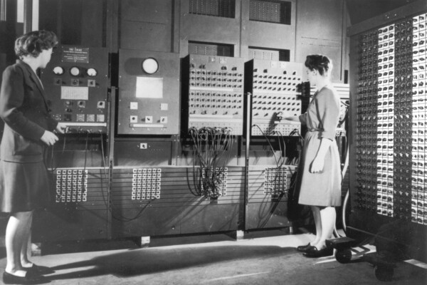 Two female programmers work on the ENIAC computer. 