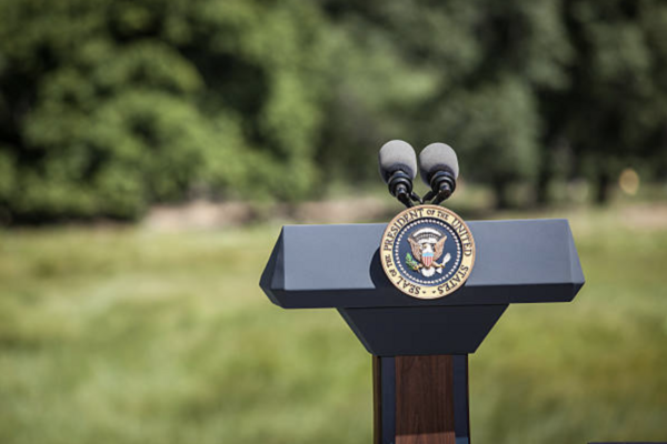Empty podium with POTUS seal on lawn