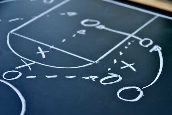 a close-up of a basketball play drawn on a chalkboard
