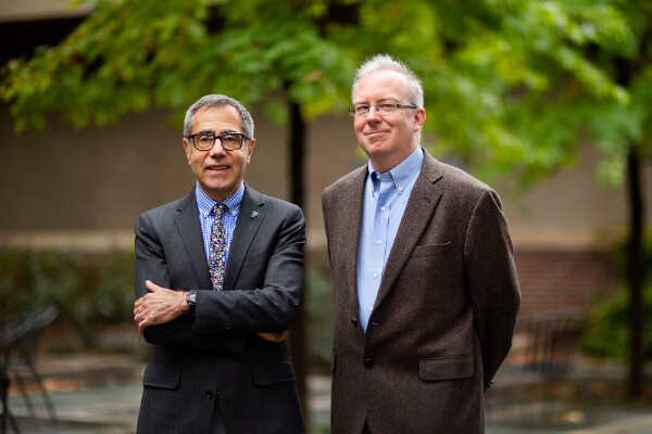 Eugene Mele and Charles Kane standing together in a courtyard