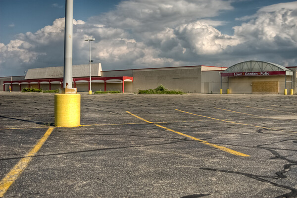 abandoned storefront and empty parking lot