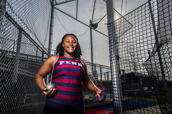 Thrower Rachel Lee Wilson poses with a hammer at the throwing field.