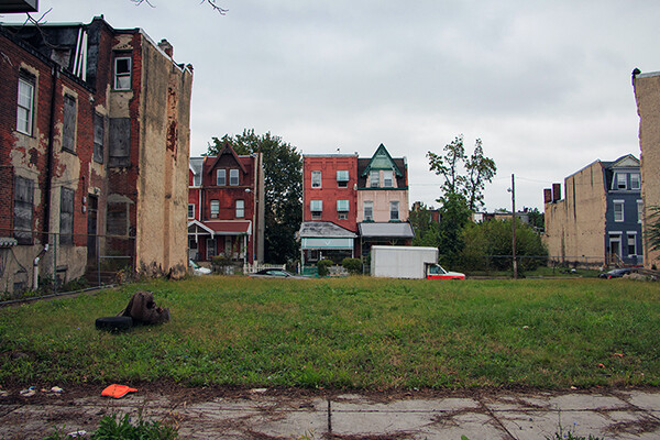 A vacant lot between rowhouses in Philadelphia