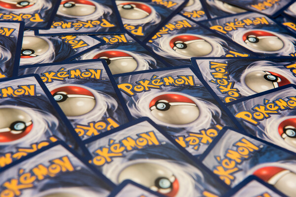Trading cards with the word Pokemon and the game's red and white ball symbol on a blue background.