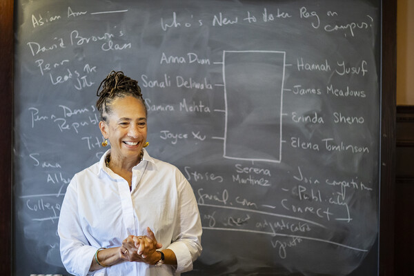 Professor standing in front of a blackboard.