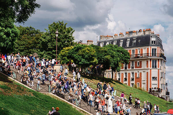 A crowd of people on an outdoor staircase in France