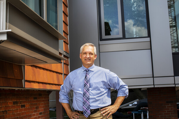 Mark Kocent in front of building mock-up