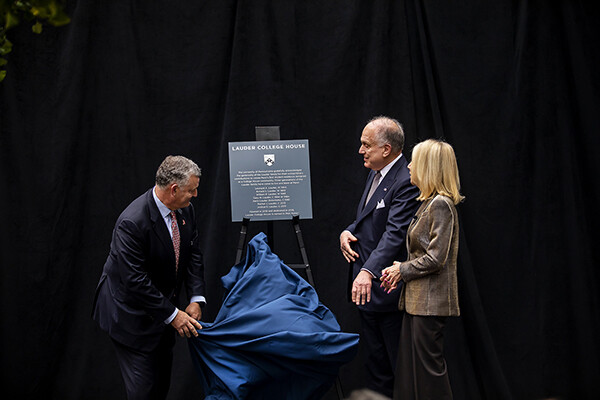 William and Ronald Lauder assist President Amy Gutmann in the revealing of the Lauder College House name.