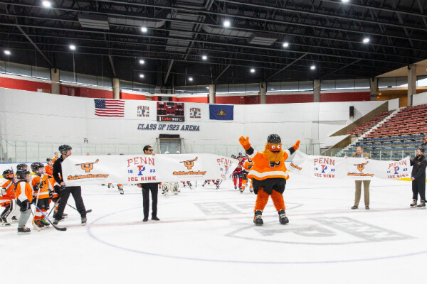 Gritty skates through ceremonial ribbon at Penn Ice Rink.