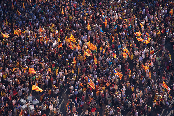 Aerial view of a large crowd in Barcelona, many holding Catalonia flags