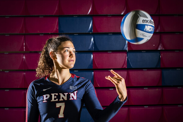 Parker Jones, a junior on the volleyball team, tosses the ball in the air during a shoot at the Palestra.