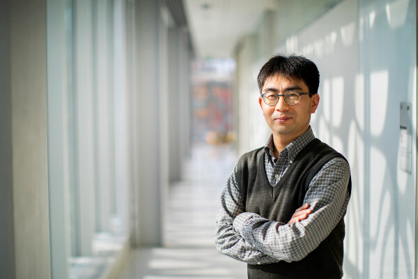 a person standing in a hallway lit with natural light